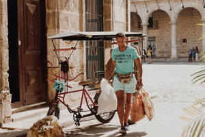 Cuban Man Carrying Bags Wallpaper