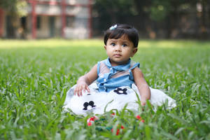 Cute Baby In A Fancy Dress On Grass Wallpaper