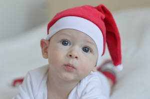 Cute Baby With Red Santa Hat Wallpaper