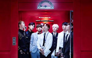Cute Bts Group In A Red Elevator Wallpaper