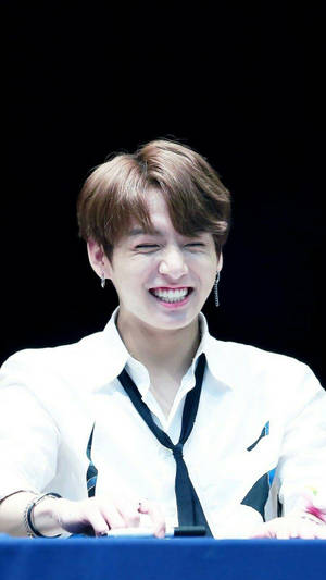 Cute Bts Jungkook Smiling At Fanmeet Wallpaper