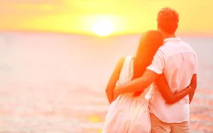 Cute Couple Watching Sunset Wallpaper