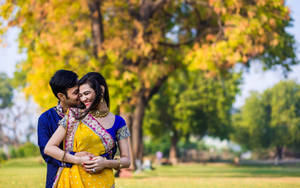 Cute Indian Couple In Wedding Attire At Park Wallpaper