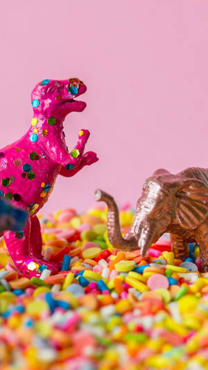 Cute Pink Dinosaur Fun On Sprinkles Wallpaper