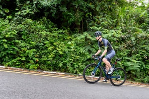 Cycling On Uphill Country Road Wallpaper