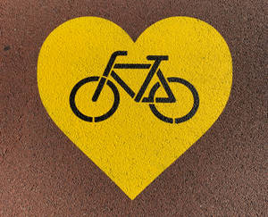 Cycling Yellow Heart Sign Wallpaper
