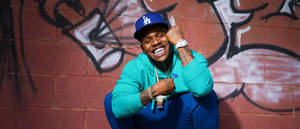 Dababy In Teal Jacket Outfit Wallpaper