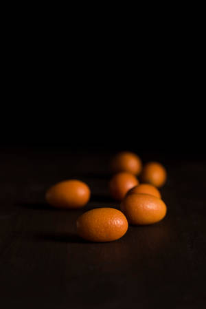 Dark Kumquat Fruits Eye Level Shot Wallpaper