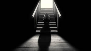 Dark Loneliness: A Solitary Figure On A Staircase Wallpaper