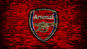 Defiant And Proud, Arsenal's Logo Graces A Stark Concrete Wall Wallpaper