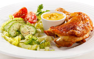 Delectable Roasted Chicken Leg With Veggie Sides Wallpaper