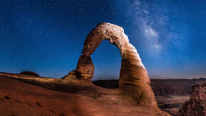 Delicate Arch Under Sea Of Stars Wallpaper