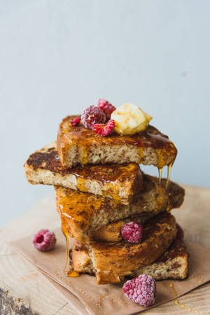 Delicious Golden Brown French Toast With Maple Syrup Wallpaper