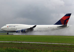 Delta Airlines Airplane Smoke On Grass Field Wallpaper