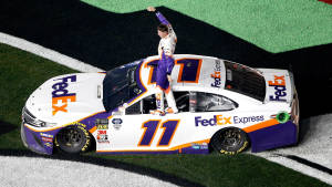 Denny Hamlin Standing On Car Door Wallpaper