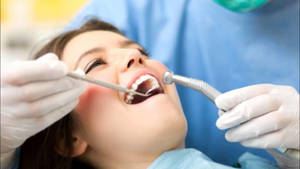 Dentist's Patient Smiling During A Procedure Wallpaper