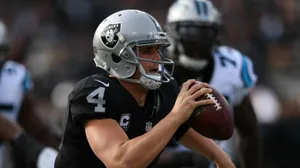 Derek Carr Holds The Football With One Hand Wallpaper