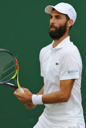 Determined Benoit Paire Gripping His Tennis Racket Wallpaper