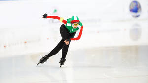 Determined Woman Speed Skating On A Frozen Path Wallpaper