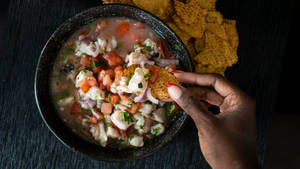 Dipping Corn Chips In Ceviche Wallpaper