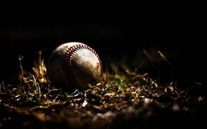 Dirty Messy Baseball On The Ground Wallpaper