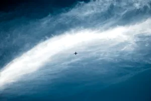 Distant Plane In Vast Sky Wallpaper