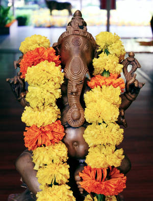Divine Ganesha With Marigold Garland On Mobile Wallpaper