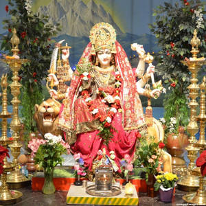 Divine Vaishno Devi Statue Adorned With Fresh Flowers Wallpaper