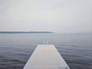 Dock At A Calming Lake Scenery Wallpaper