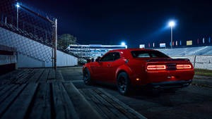 Dodge Challenger In Crimson Red - A Blend Of Power And Style Wallpaper