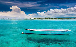 Drifting Boat On Blue Water Wallpaper