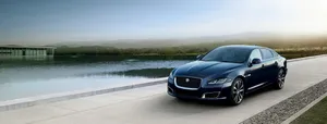 Driving Matte Black Jaguar Car Wallpaper