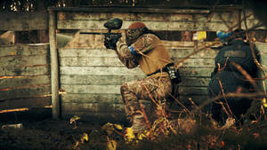 Duo Paintball Players In The Woods Wallpaper