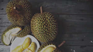 Durian Fruit Displayon Wooden Table Wallpaper