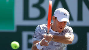 Dynamic Diego Schwartzman Chasing A Tennis Ball In Court Wallpaper