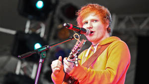 Ed Sheeran In Orange Jacket Wallpaper