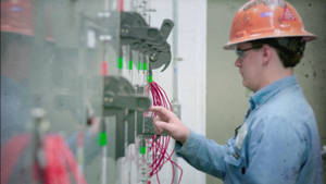 Electrician At Work Configuring Switches Wallpaper