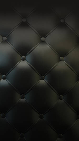 Elegant Black Iphone Against Leather Upholstery Wallpaper