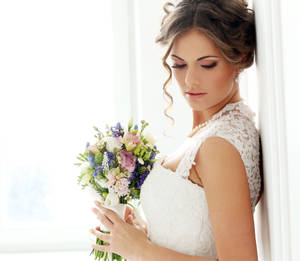 Elegant Bride In A Detailed Wedding Gown Wallpaper