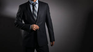 Elegant Businessman In Sophisticated Suit Wallpaper