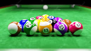 Elegant Game In Progress On A Polished Pool Table Wallpaper