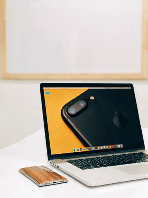 Elegant Macbook Pro On A White Surface Wallpaper