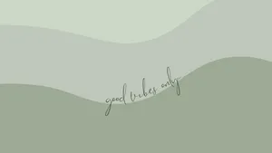 Elegant Sage Green Laptop On A Minimalist Desk Setup Wallpaper