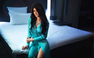 Elegant Woman In Turquoise Dress_ Bedroom Setting Wallpaper