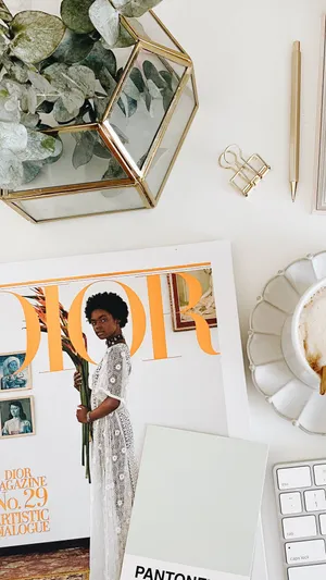 Elegant Workspacewith Dior Magazine Wallpaper