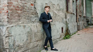 Elegant Young Man In Classy Black Suit Wallpaper