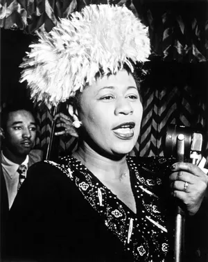 Ella Fitzgerald Holding A Microphone Wallpaper