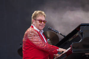 Elton John Pianist In Red Suit Wallpaper