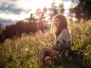 Embracing Nature With Curls - A Woman With Curly Hair Outdoors Wallpaper