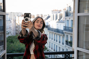 Emily In Paris Taking Selfie Wallpaper
